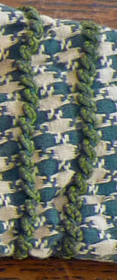 There are rows of trim on cuffs, shoulder caps, and bodice.
