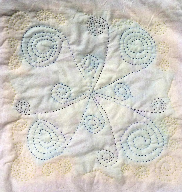 Block C reverse.  I had fun stitching these spirals, without worrying if they all faced the same way.  But I'm not good at stitching in any direction, so I had to turn the hoop a lot.