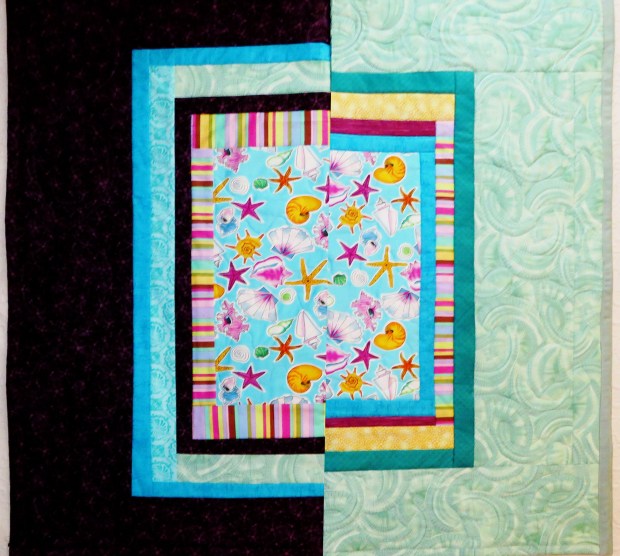 Two quilts, folded in half, to compare the fabric combinations.