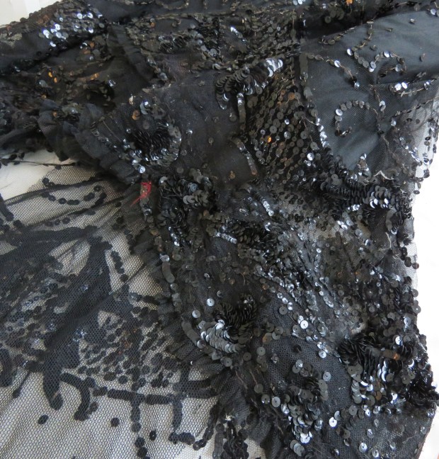Detail of the layers of cloth and embellishment at the hemline.