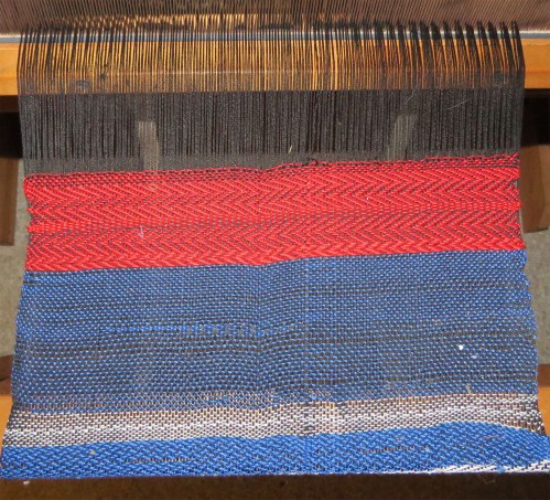 The red twill is where the 7-year-old started weaving.