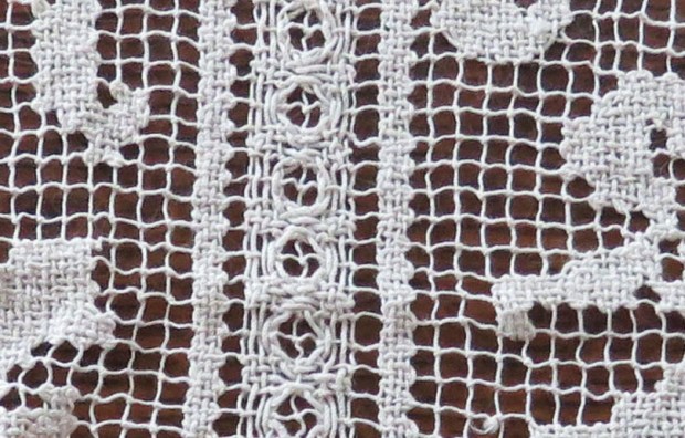 Detail of #1 - a knotted netting, with areas filled in with needle and thread.