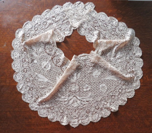 Silk scarf. It drapes beautifully on a person but does not lay flat well!