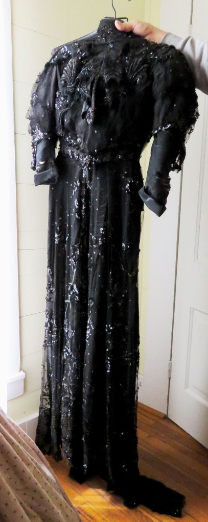 The gown being held up in the light (only for a moment!) by my patient husband.