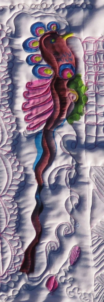 A Red-Crested Bobble-Headed bird, created as to disguise some weak quilting and an ugly background fabric.