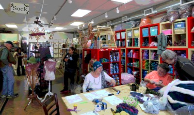 The quintessential yarn shop -- teaching, browsing, reading, and chatting going on in one bright colorful space.