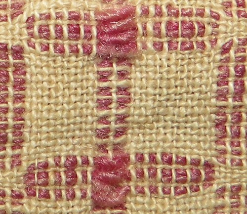 More evidence of the human touch -- throughout the piece, the little white blocks on the left have 12 warp threads, and on the right they have 14.