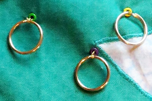 Detail of the jump rings wired through the eyelets.