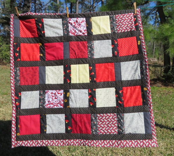 Black and White and Red All Over lap quilt.
