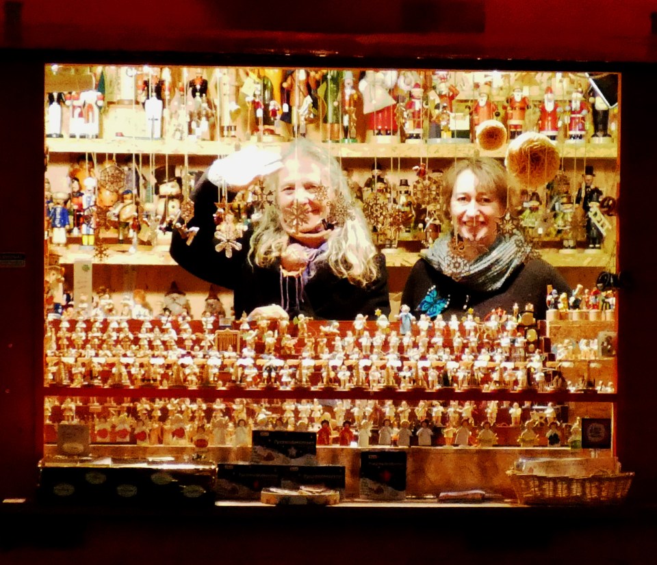 Two ladies selling wooden ornaments at Dusseldorf Christmas market.
