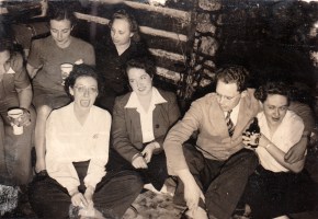 a group of people in a log cabin c. 1935