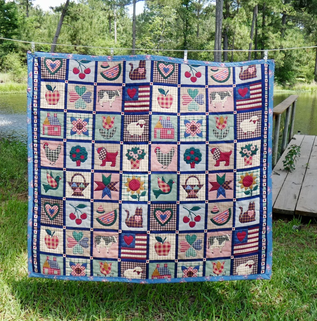 lap quilt made from fabric printed to look like intricate applique