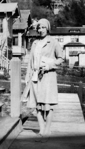 Woman in suit with handbag and cap, 1930s