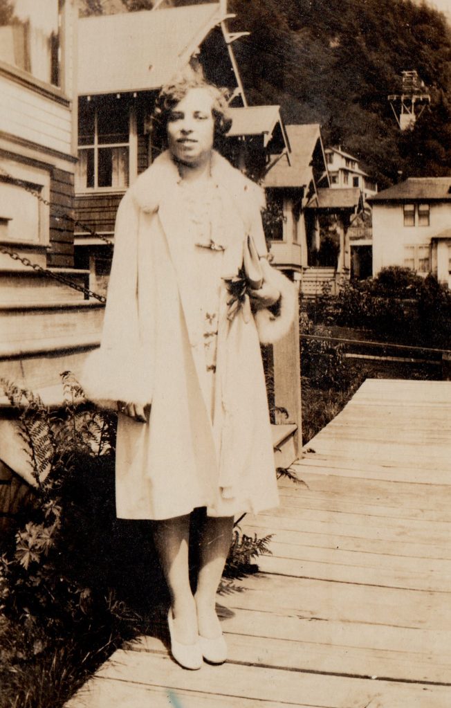 woman in pale coat with fur trim, Alaska, 1930s